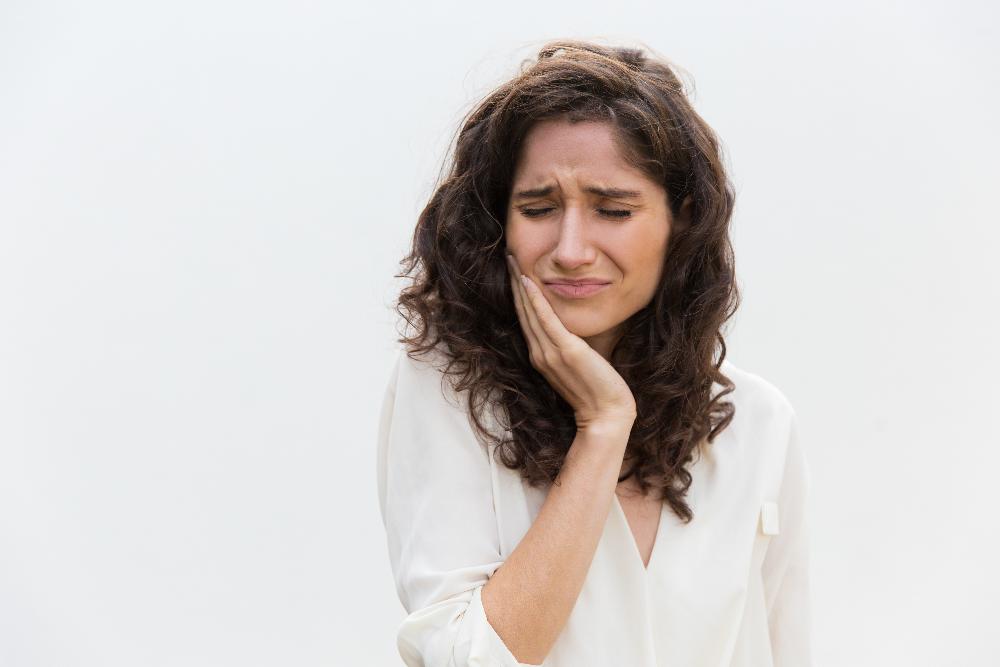 Woman holding her jaw in pain, south charlotte nc