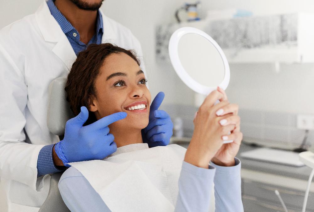 Woman holding mirror towards mouth, south charlotte nc