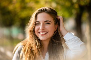 Beautiful woman in a white shirt smiling
