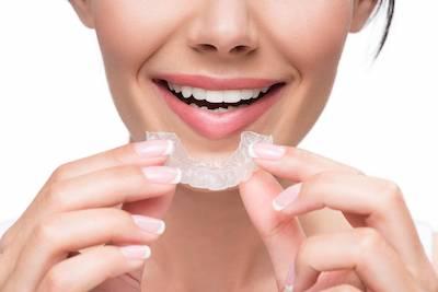 Woman with invisalign clear aligner, south charlotte nc