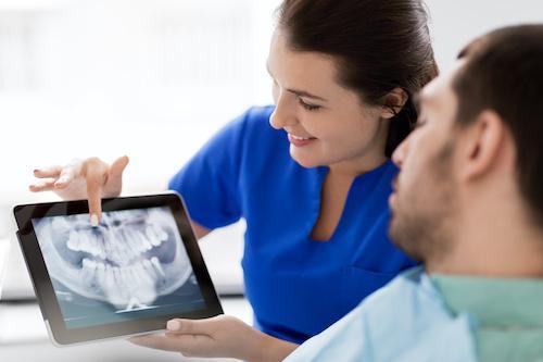 Patient looking at xrays in tablet, south charlotte nc