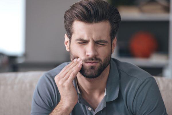 Man touching his jaw in pain, south charlotte