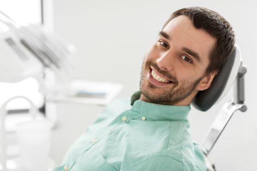 Man sitting in dental chair smiling, south charlotte nc