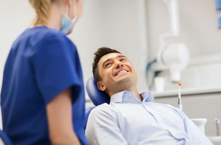 Man sitting in dental chair smiling in charlotte, nc