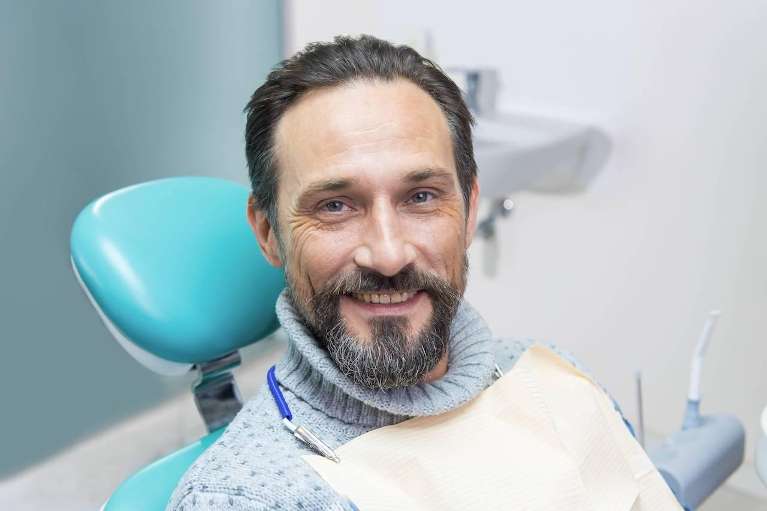 Man smiling in dental chair smiling, south charlotte nc
