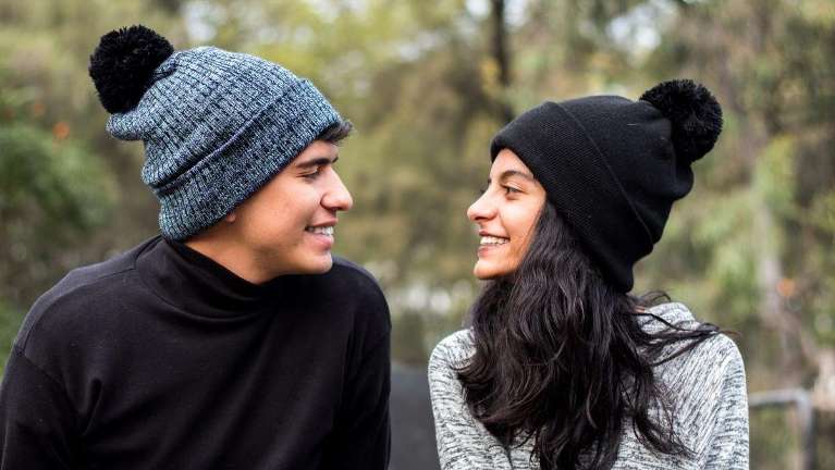 man and woman smiling at one another 