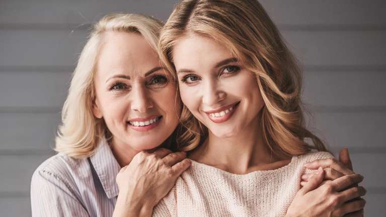 mom and daughter smiling