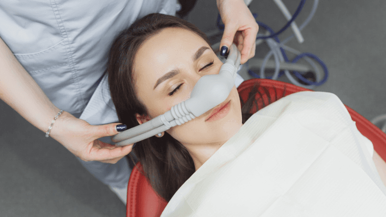 Woman in dental chair getting dental sedation, charlotte nc