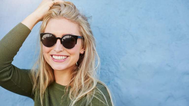 woman with sunglasses smiling