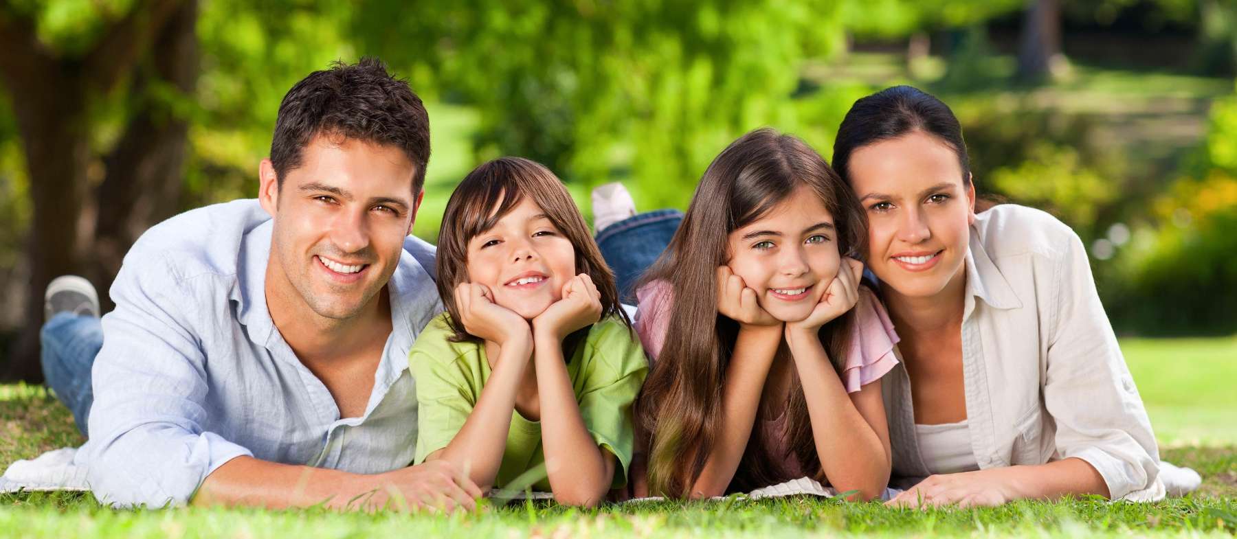 White family smiling together on a blanket, south charlotte nc