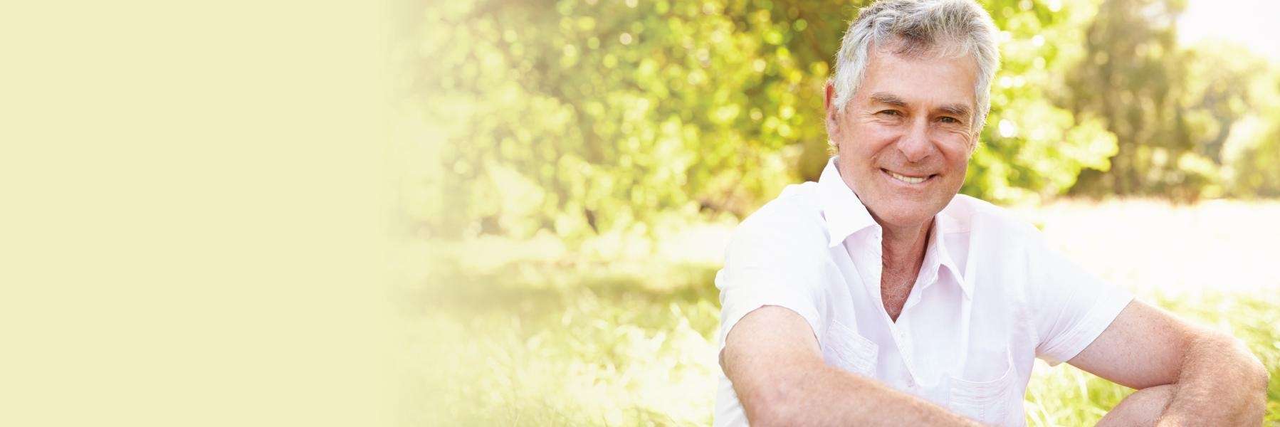 A man sitting down while smiling