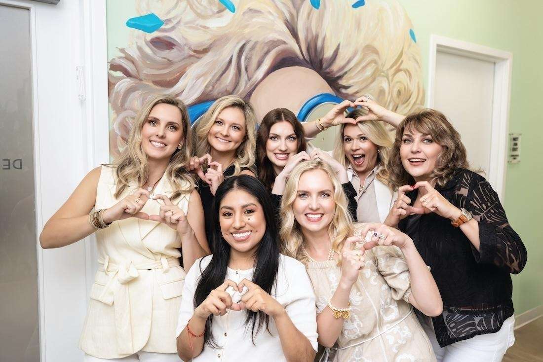 Dental Wellness of Charlotte team making hearts, charlotte nc