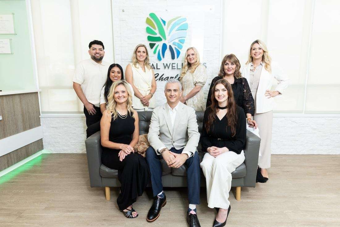 Dental Wellness of Charlotte team sitting and standing, charlotte nc