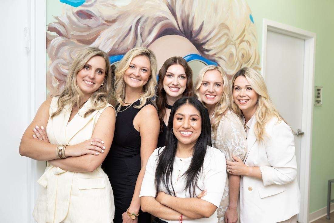 Dental Wellness of Charlotte team standing and smiling, charlotte nc